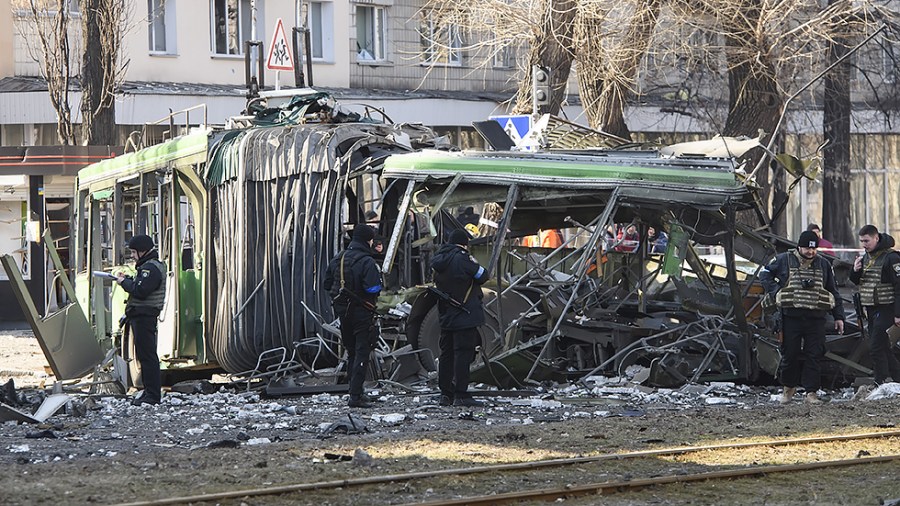 Ukrainian police inspect the site of a Russian bombing attack in front of a destroyed apartment building in Kyiv, Ukraine on Monday, March 14, 2022. City officials claim two people were killed as neighborhoods around Kyiv come under Russian shelling.