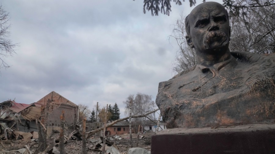 A bust of Taras Shevchenko, Ukrainian poet and national symbol, stands against the devastation after a night air raid in the village of Byshiv