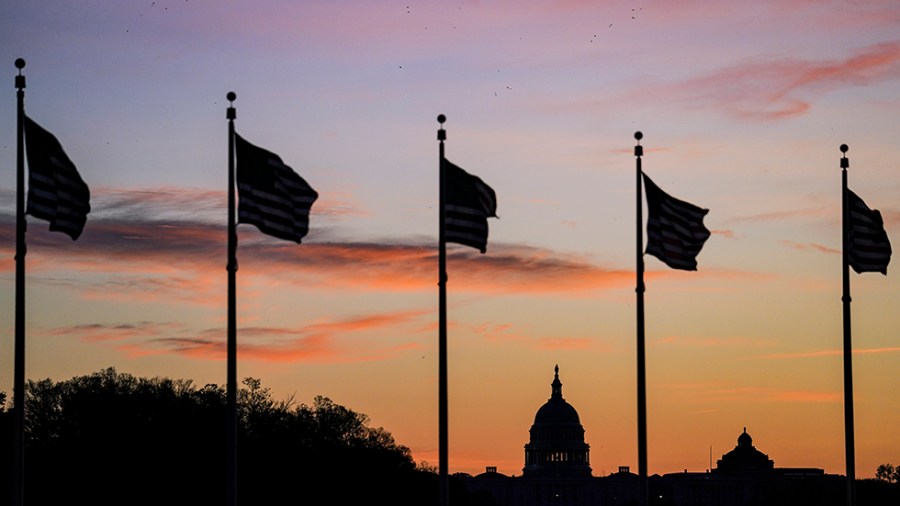 The U.S. Capitol is silhouetted against the early morning sky