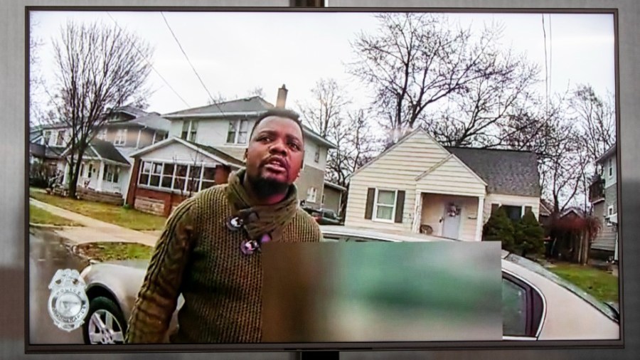 A TV display shows video evidence of a Grand Rapids police officer struggling with and shooting Patrick Lyoya at Grand Rapids City Hall