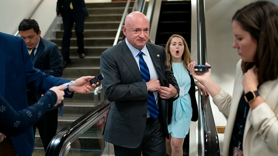 Sen. Mark Kelly (D-Ariz.) speaks to reporters following procedural votes for nominations on Tuesday, April 5, 2022.