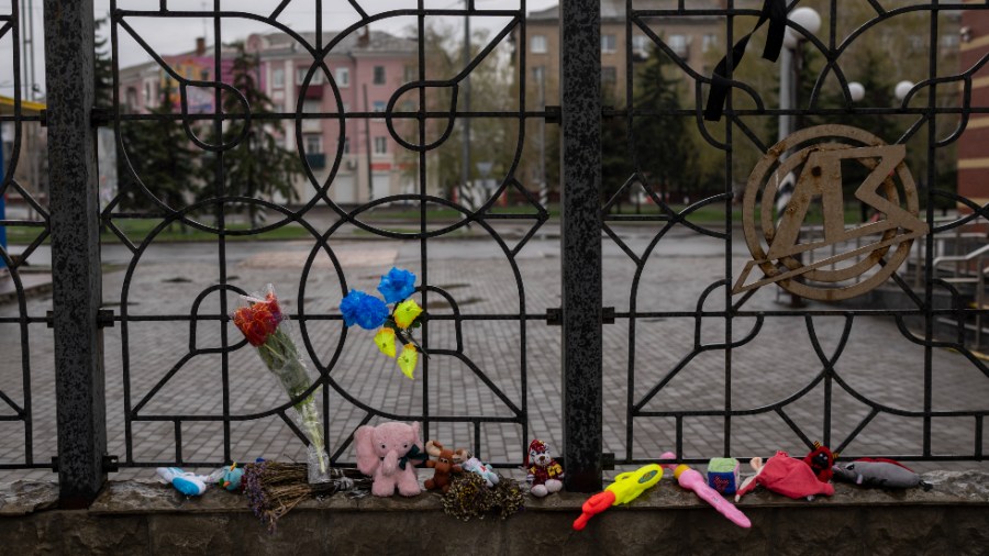 Flowers and toys were left on a fence at the railway station in Kramatorsk, Ukraine