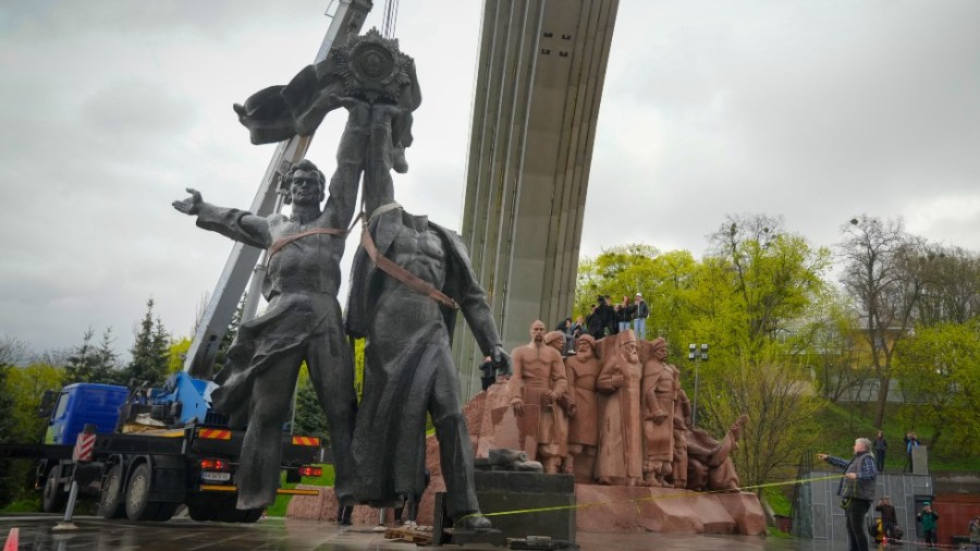 A Soviet era monument to a friendship between Ukrainian and Russian nations is seen during its demolition in central Kyiv, Ukraine