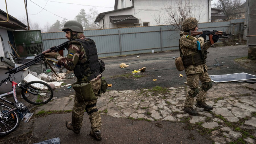 Ukrainian soldiers inspect abandoned houses used by Russian soldiers during the occupation of villages on the outskirts of Kyiv