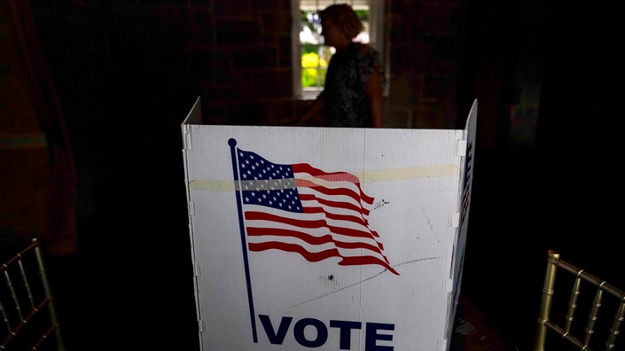 A person waits to vote