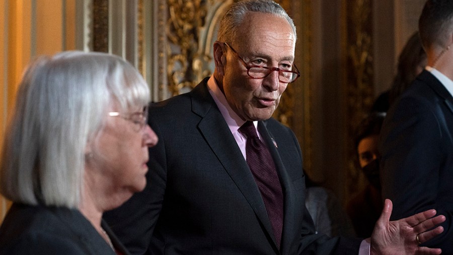 Charles Schumer gestures while talking