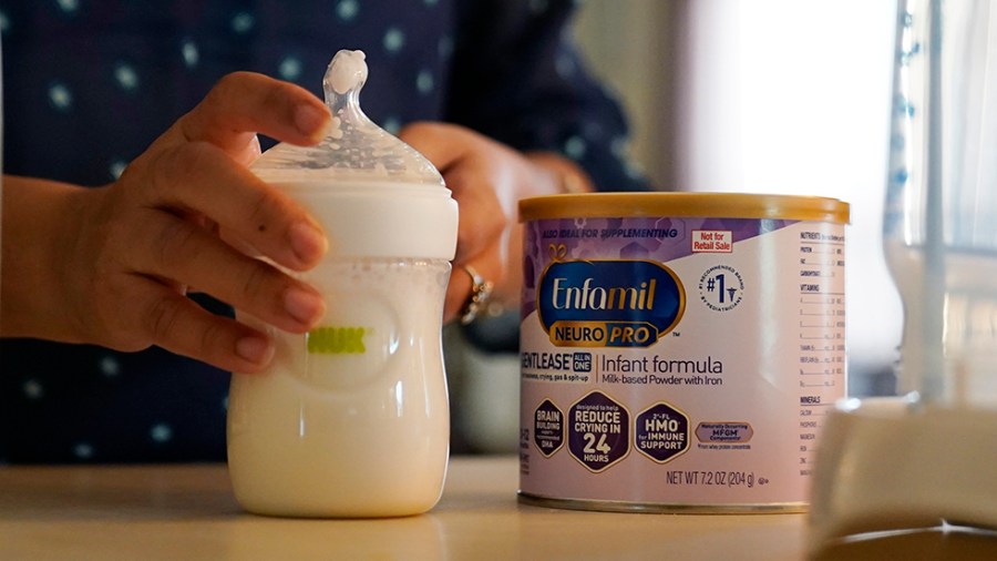 Olivia Godden prepares a bottle of baby formula