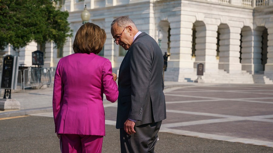 Nancy Pelosi and Charles Schumer speak privately before an event