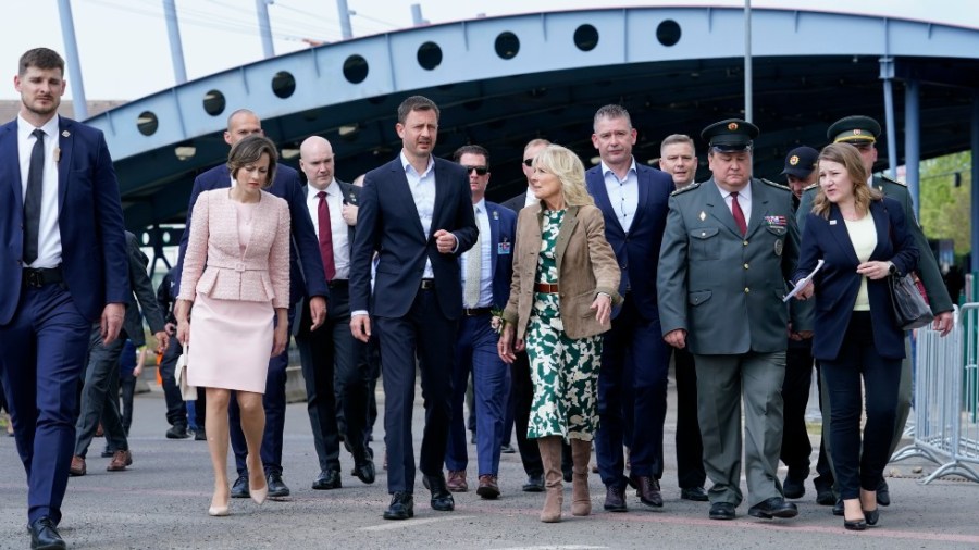 First lady Jill Biden speaks with Slovakia's Prime Minister Eduard Heger as she walks from Vysne Nemecke, Slovakia, towards the border with Ukraine