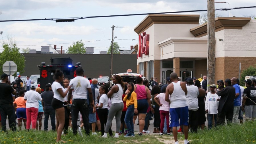 A crowd gathers as police investigate after a shooting at a supermarket on Saturday, May 14, 2022, in Buffalo, N.Y.