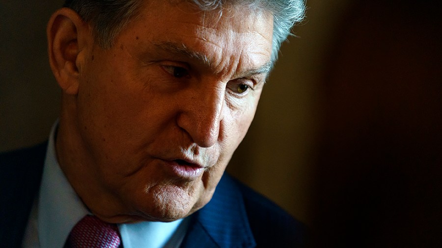 Sen. Joe Manchin (D-W.Va.) speaks to a reporter before the weekly Senate Democratic policy luncheon on Wednesday, May 18, 2022.