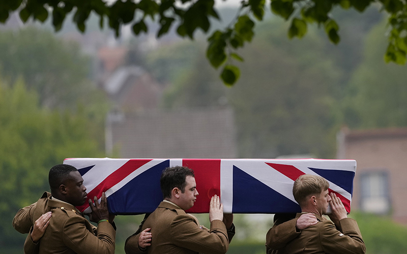 Pallbearers from the Royal Regiment of Scotland carry the British-flag draped coffin of World War I soldier Pvt. William Johnston