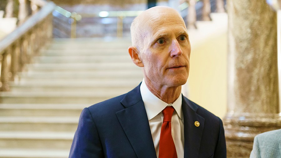 Sen. Rick Scott (R-Fla.) speaks to a reporter as he leaves a Senate Republican Conference luncheon on Wednesday, May 11, 2022.