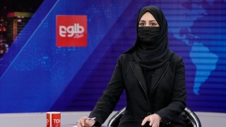 Khatereh Ahmadi a TV anchor wears a face covering as she reads the news on TOLO NEWS, in Kabul, Afghanistan