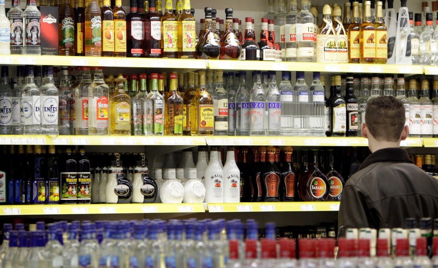 Man looks at alcohol in store