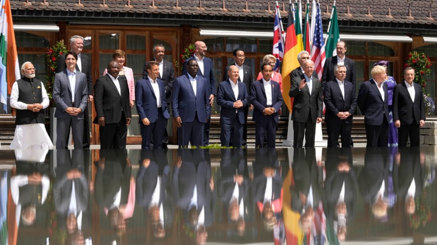 U.S. President Joe Biden, front fourth right, waves as he poses with G7 leaders and Outreach guests for an official group photo at Castle Elmau in Kruen