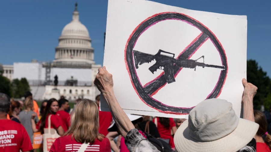 Jane Harman, from Takoma Park, Md., holds a sign during a Students Demand Action event, near the West Front of the U.S. Capitol