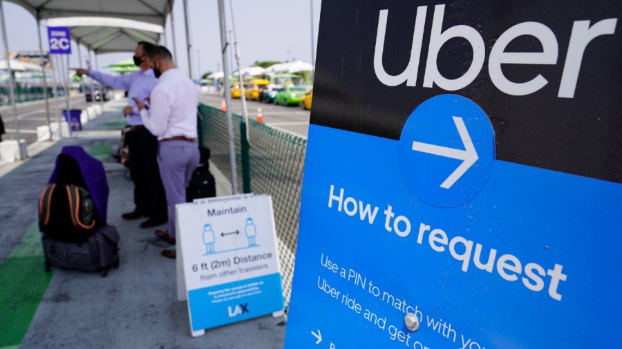 Travelers request an Uber ride at Los Angeles International Airport's LAX-it pick up terminal