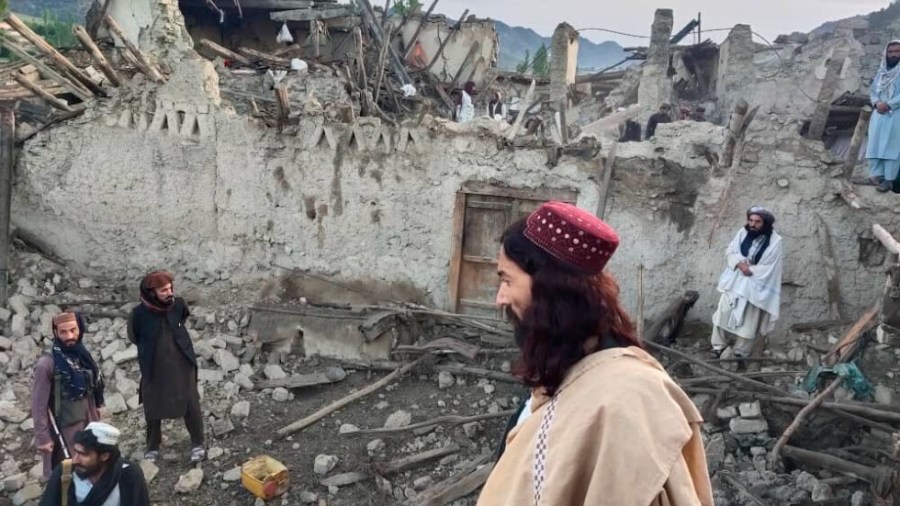 n this photo released by a state-run news agency Bakhtar, Afghans look at destruction caused by an earthquake in the province of Paktika