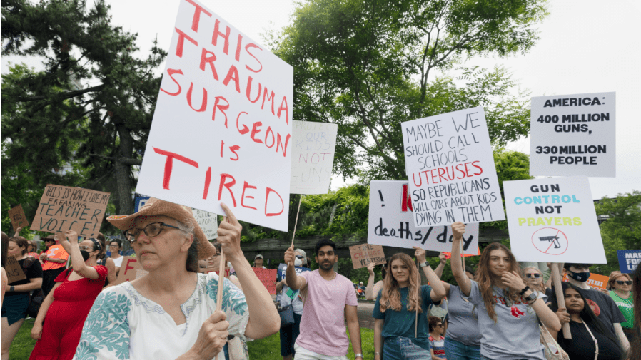 Gun control advocates protest in Christopher Columbus Park, Saturday, June 11, 2022, in Boston.