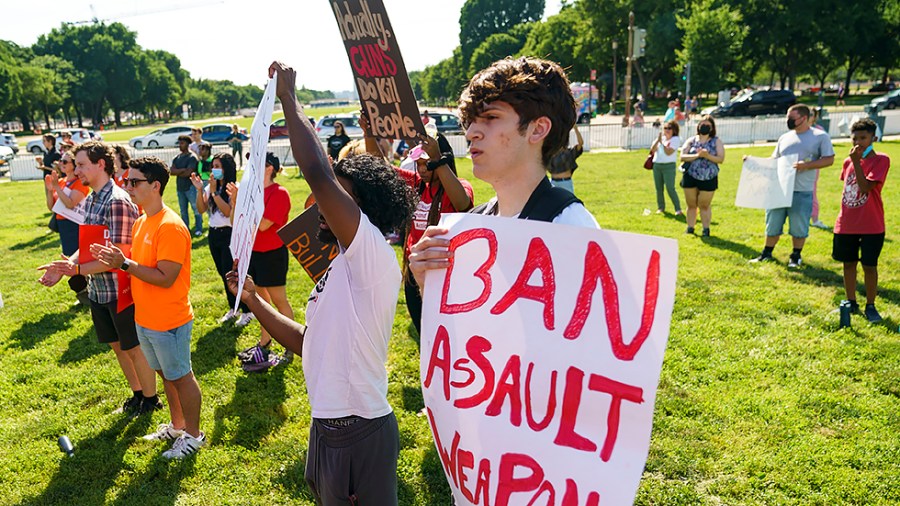 People for gun reform hold signs as they attend a rally held by multiple groups outside the U.S. Capitol in Washington, D.C., on Monday, June 6, 2022.