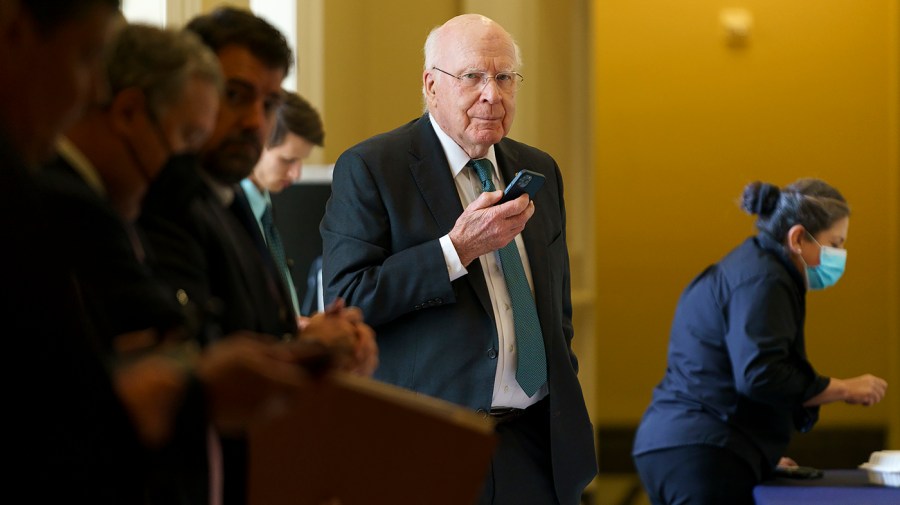 Sen. Patrick Leahy (D-Vt.) is seen on the phone as he leaves the weekly Senate Democratic policy luncheon on Wednesday, June 22, 2022.