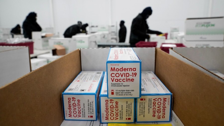 Boxes containing the Moderna COVID-19 vaccine are prepared to be shipped at the McKesson distribution center in Olive Branch, Miss.