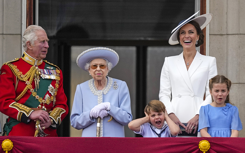 Prince Charles, from left, Queen Elizabeth II, Prince Louis, Kate, Duchess of Cambridge, and Princess Charlotte watch a flyover as Prince Louis covers his ears