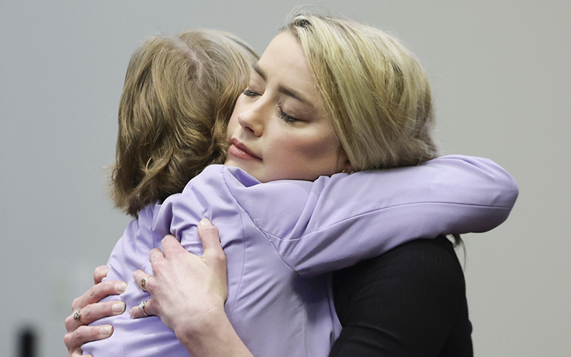 Actor Amber Heard hugs her lawyer Elaine Bredehoft after the verdict was read