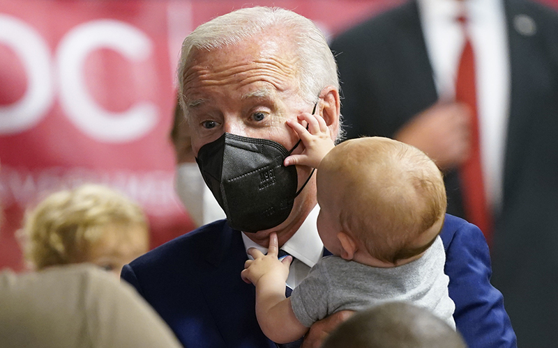 President Biden meets a baby who interacts with his mask