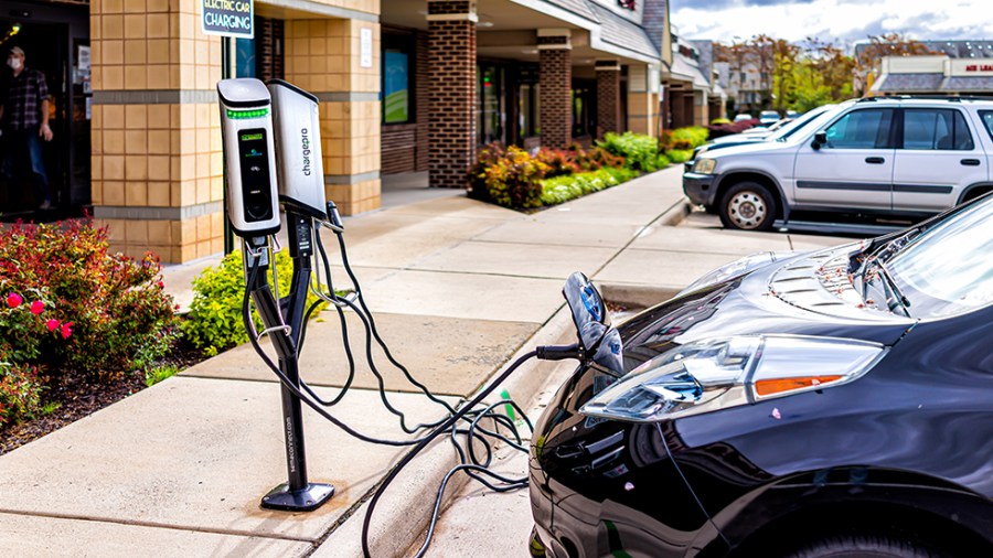 An electric car is seen charging of Mom's Organic Market in Herndon, Virginia on April 27, 2020.