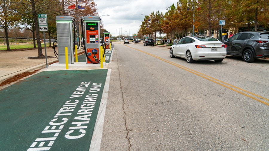 Chargepoint stations are seen roadside as cars pass in downtown Austin, Texas