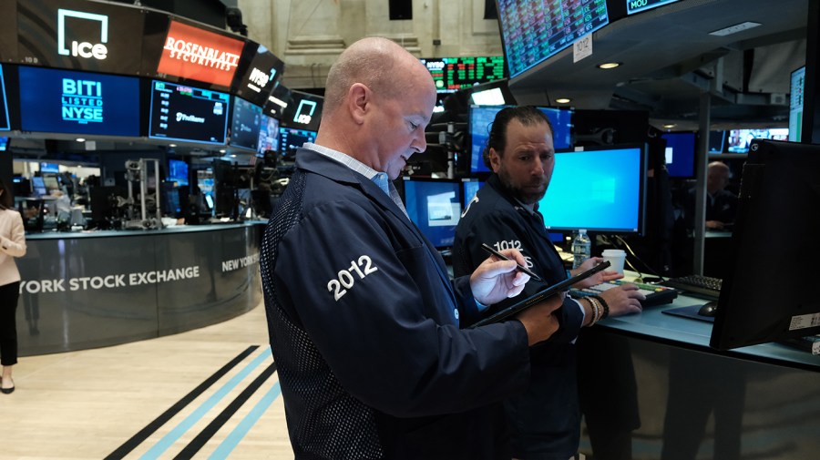 Traders work on the floor of the New York Stock Exchange