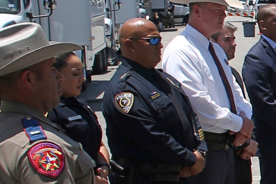 Pete Arredondo stands in a line with other law enforcement personnel.