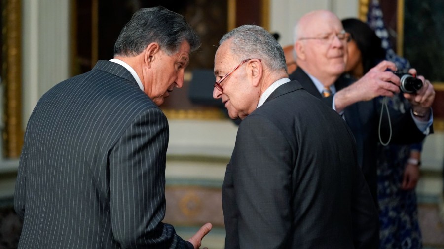 en. Joe Manchin, D-W.Va., talks with Senate Majority Leader Chuck Schumer of N.Y., before an event in the Indian Treaty Room in the Eisenhower Executive Office Building on the White House Campus in Washington, Tuesday, March 15, 2022.