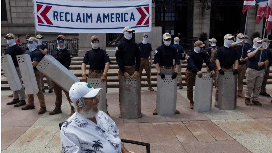 People bearing the insignia of the white supremacist group Patriot Front stand in front of the Boston Public Library in Copley Square on Saturday, July 2, 2022, in Boston.