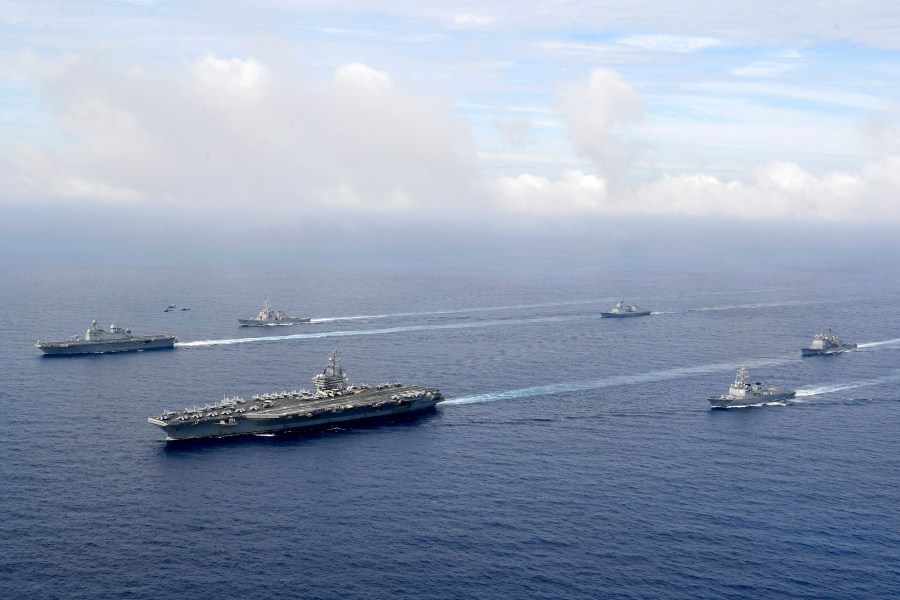 U.S. nuclear-powered aircraft carrier USS Ronald Reagan, second from left, and South Korea's landing platform helicopter (LPH) ship Marado, left, sail during a joint military exercise