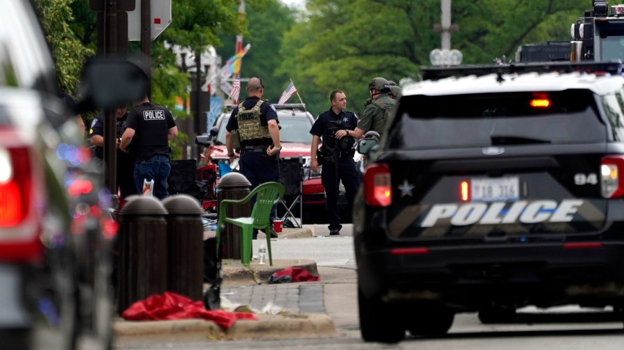 Law enforcement search in downtown Highland Park, a Chicago suburb, after a mass shooting at a Fourth of July parade.