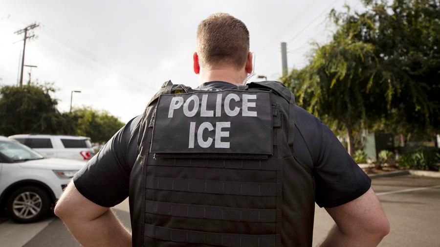 A U.S. Immigration and Customs Enforcement officer looks on during an operation