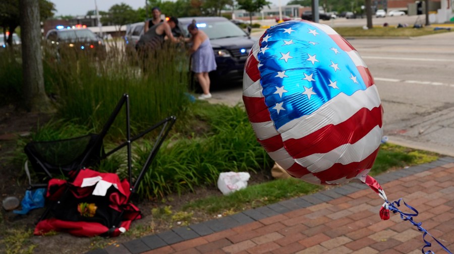 People check their belongings after a mass shooting at a Fourth of July parade in downtown Highland Park, Ill., a suburb of Chicago.