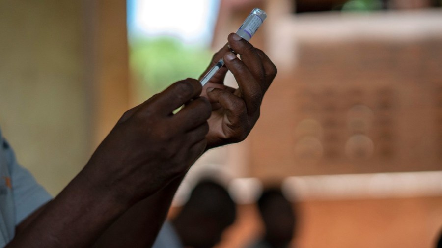 FILE - Health officials prepare to administer a vaccine in the Malawi village of Tomali with the world's first vaccine against malaria in a pilot program in Tomali, Dec. 11, 2019.