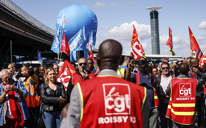 Union strikers demonstrate outside a terminal at Roissy airport