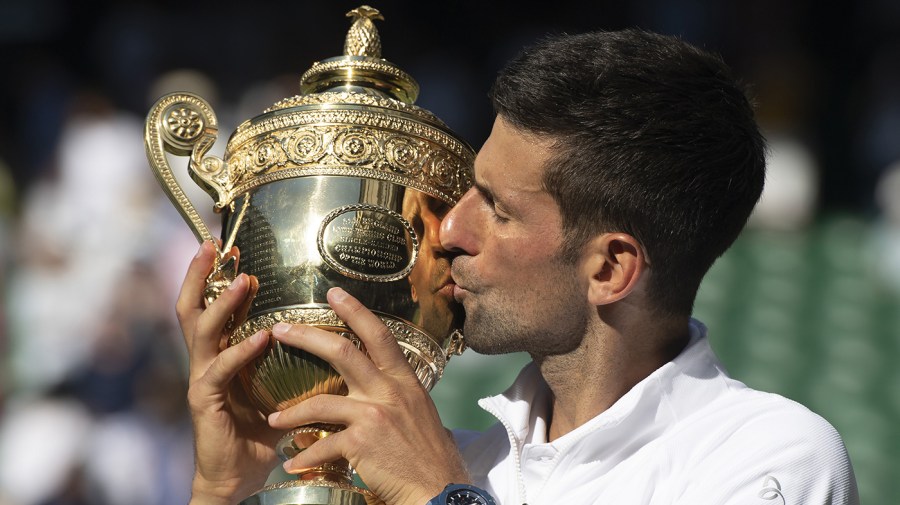 Serbian Novak Djokovic kisses the Wimbledon trophy