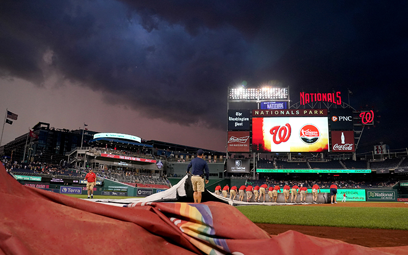 The rain cover is pulled during the Congressional Baseball Game