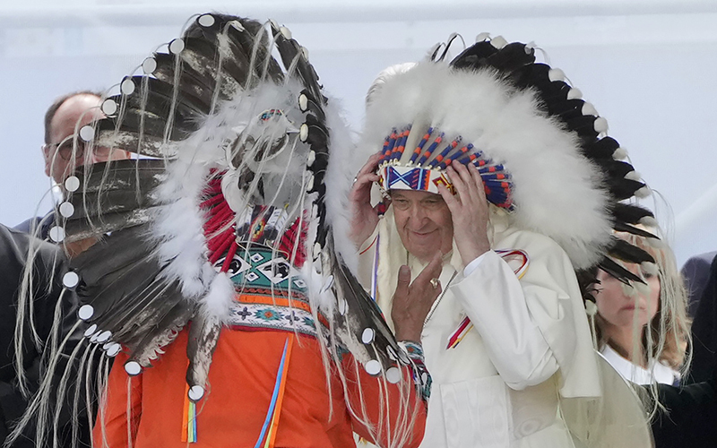 Pope Francis puts on a headdress