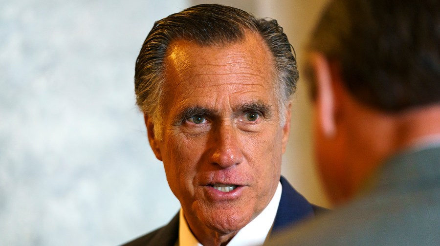 Sen. Mitt Romney (R-Utah) speaks to a reporter as he arrives to the Senate Chamber for a series of procedural votes regarding nominations on Tuesday, July 19, 2022.