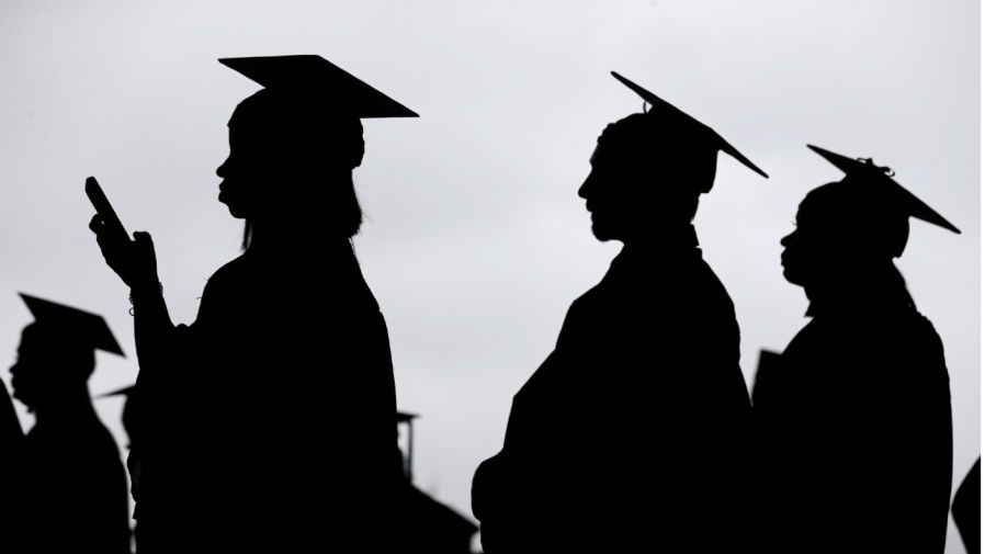 FILE - In this May 17, 2018, file photo, new graduates line up before the start of the Bergen Community College commencement at MetLife Stadium in East Rutherford, N.J.