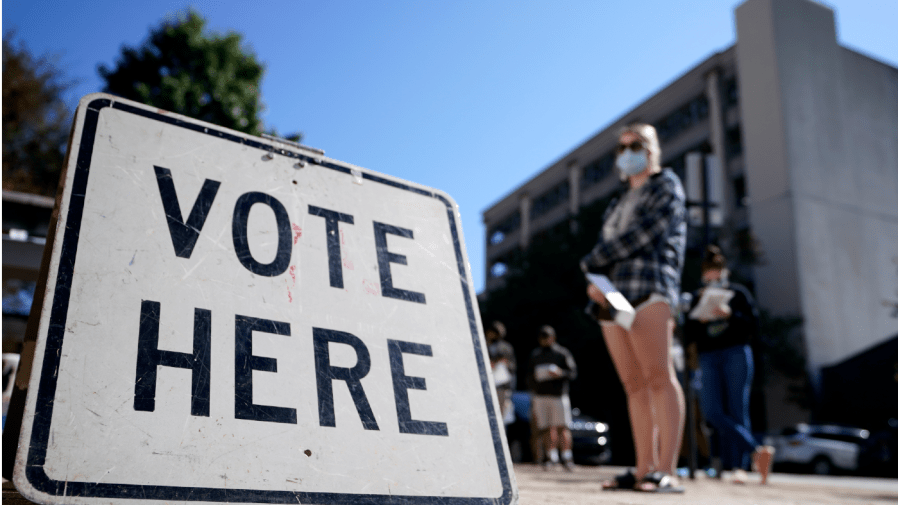 FILE - Voters stand in a line as they wait to vote early on Oct. 19, 2020, in Athens, Ga.