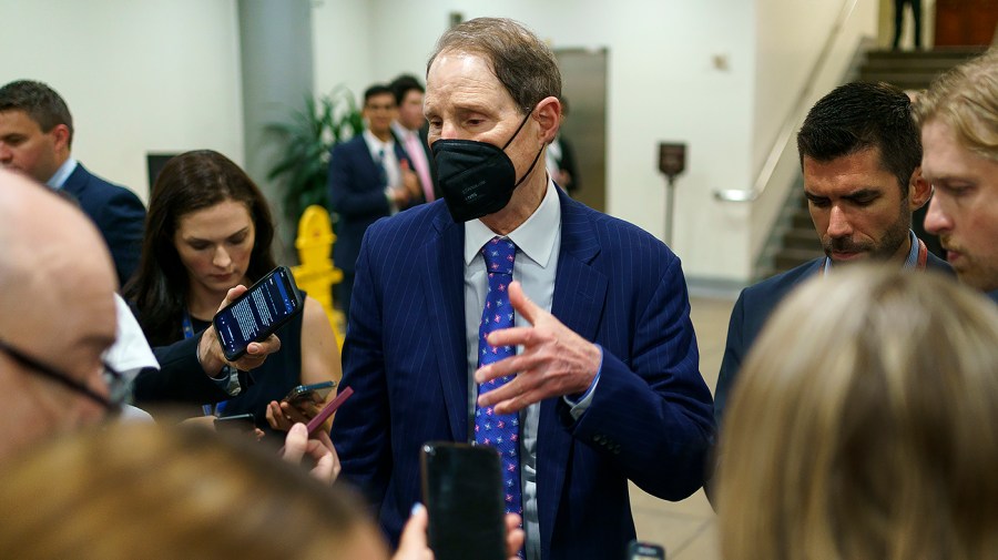 Sen. Ron Wyden (D-Ore.) speaks to reporters following procedural votes regarding the nomination of Federal Reserve Board Member nominee Michael Barr on Wednesday, July 13, 2022.