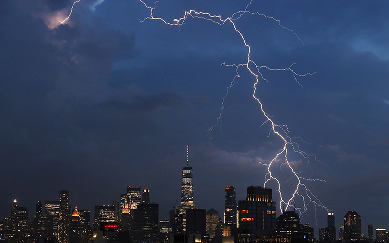 A bolt of lightning strikes behind One World Trade Center